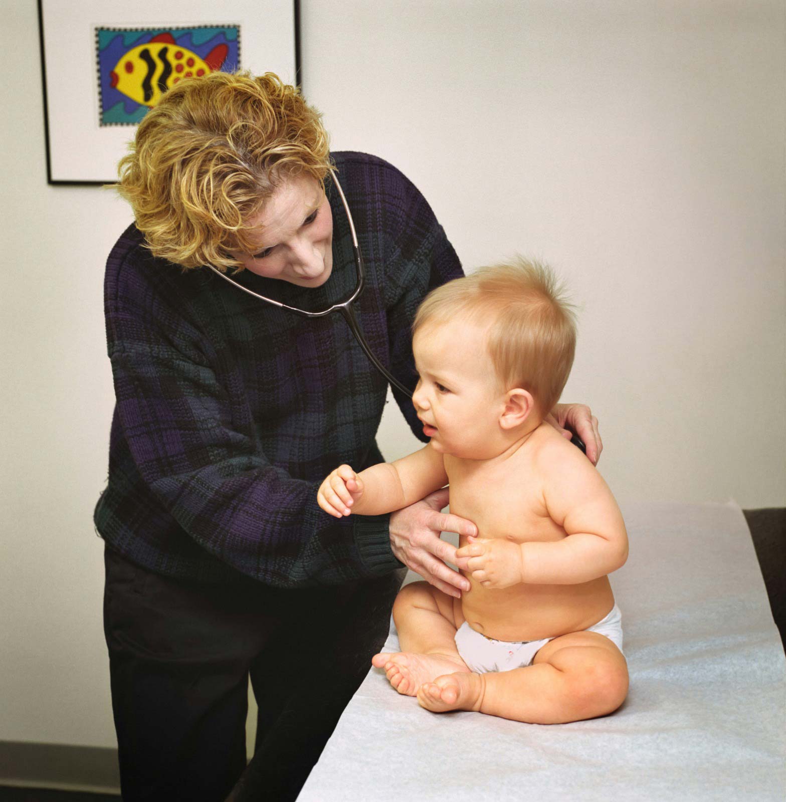 Pediatrician examining an infant